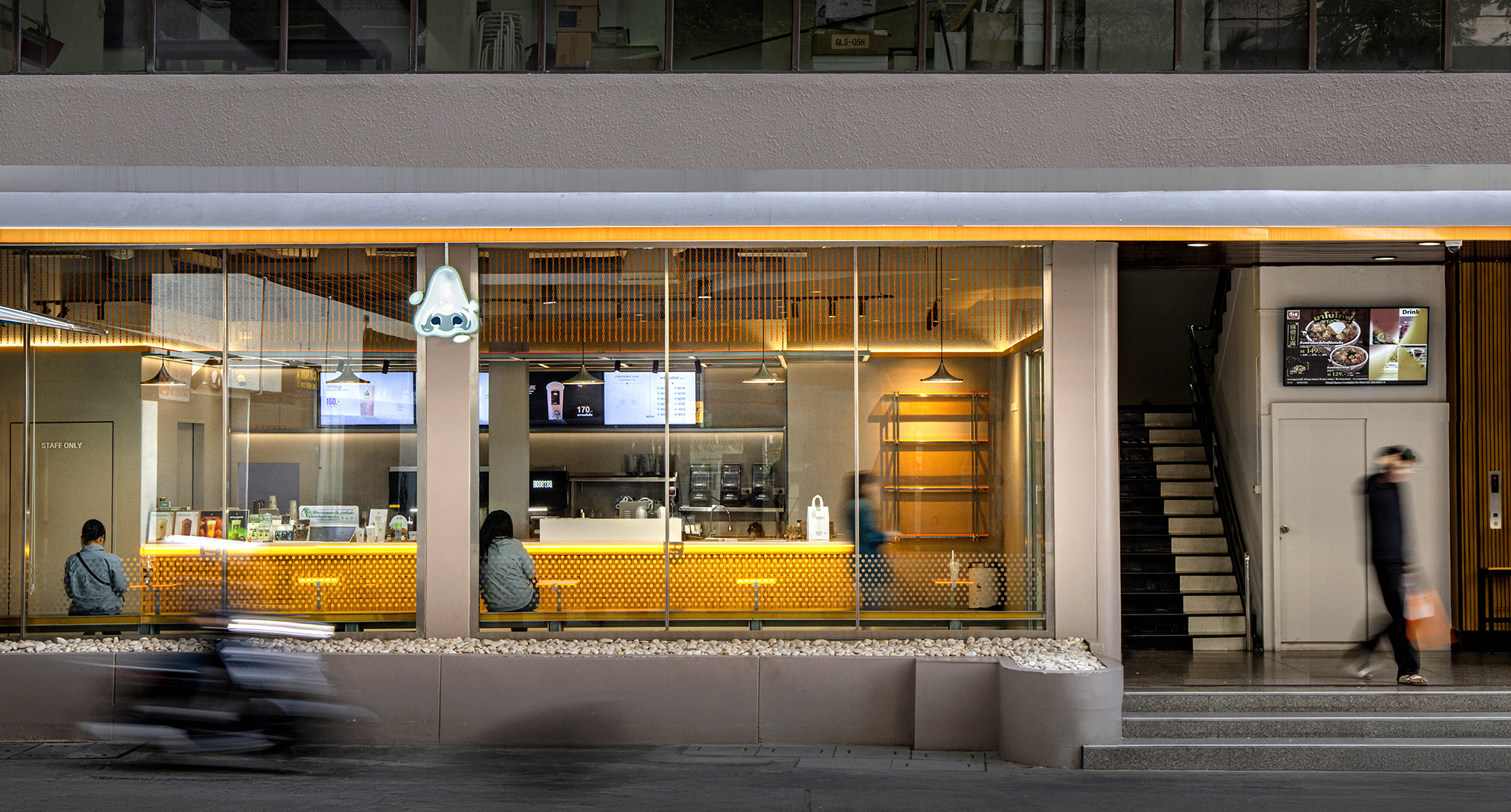 Nose Tea storefront at dusk
